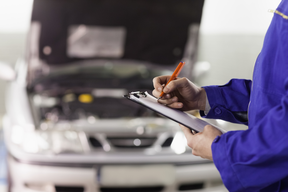 Mechanic with Clipboard Checking Car Maintenance Tasks